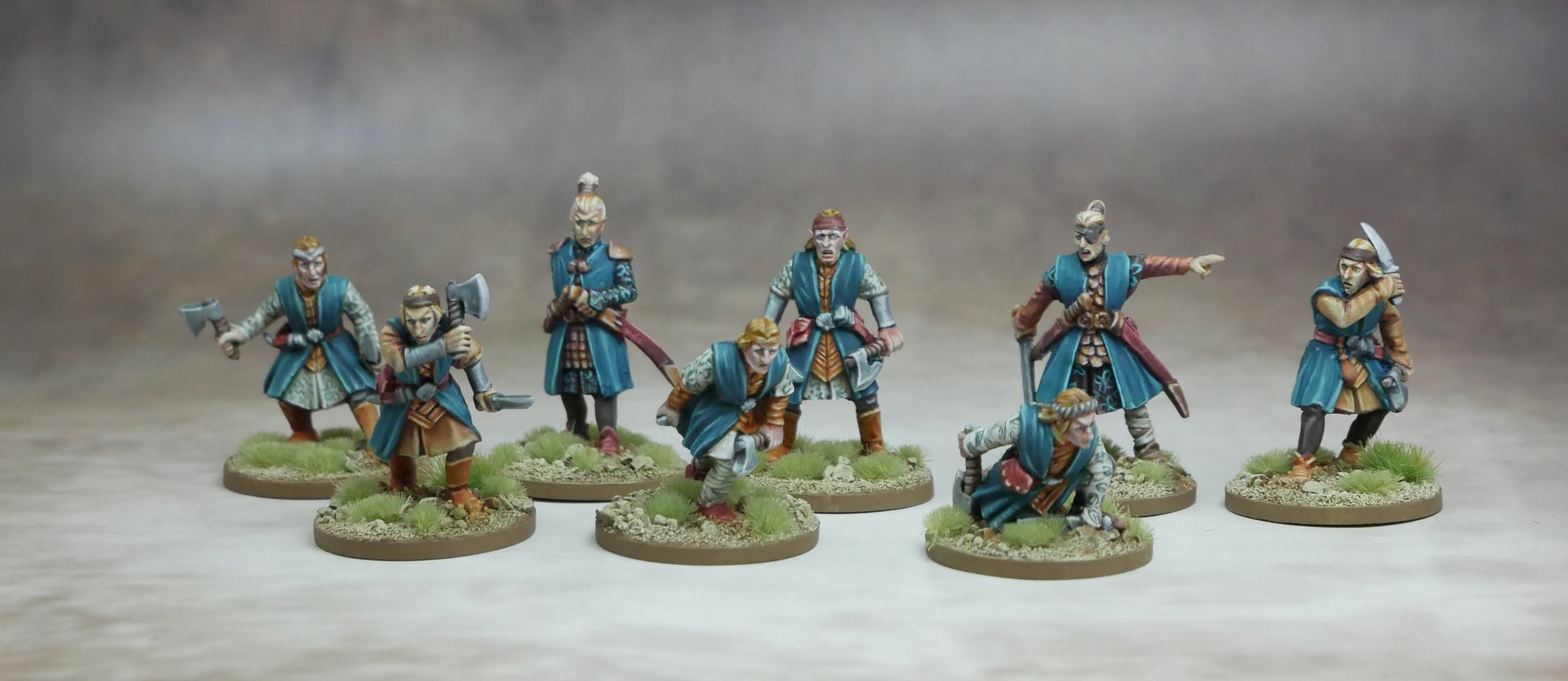 A group of Elven Marines figurines in blue attire, showcasing their unique weapons and combat readiness.