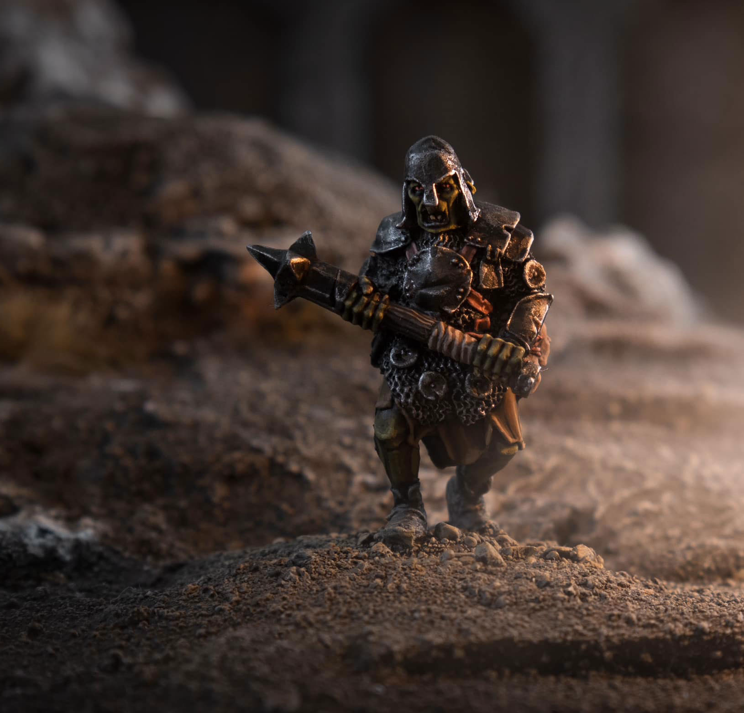 Orc Linebreaker Berserkers miniature wielding weapon in a rocky terrain setting.