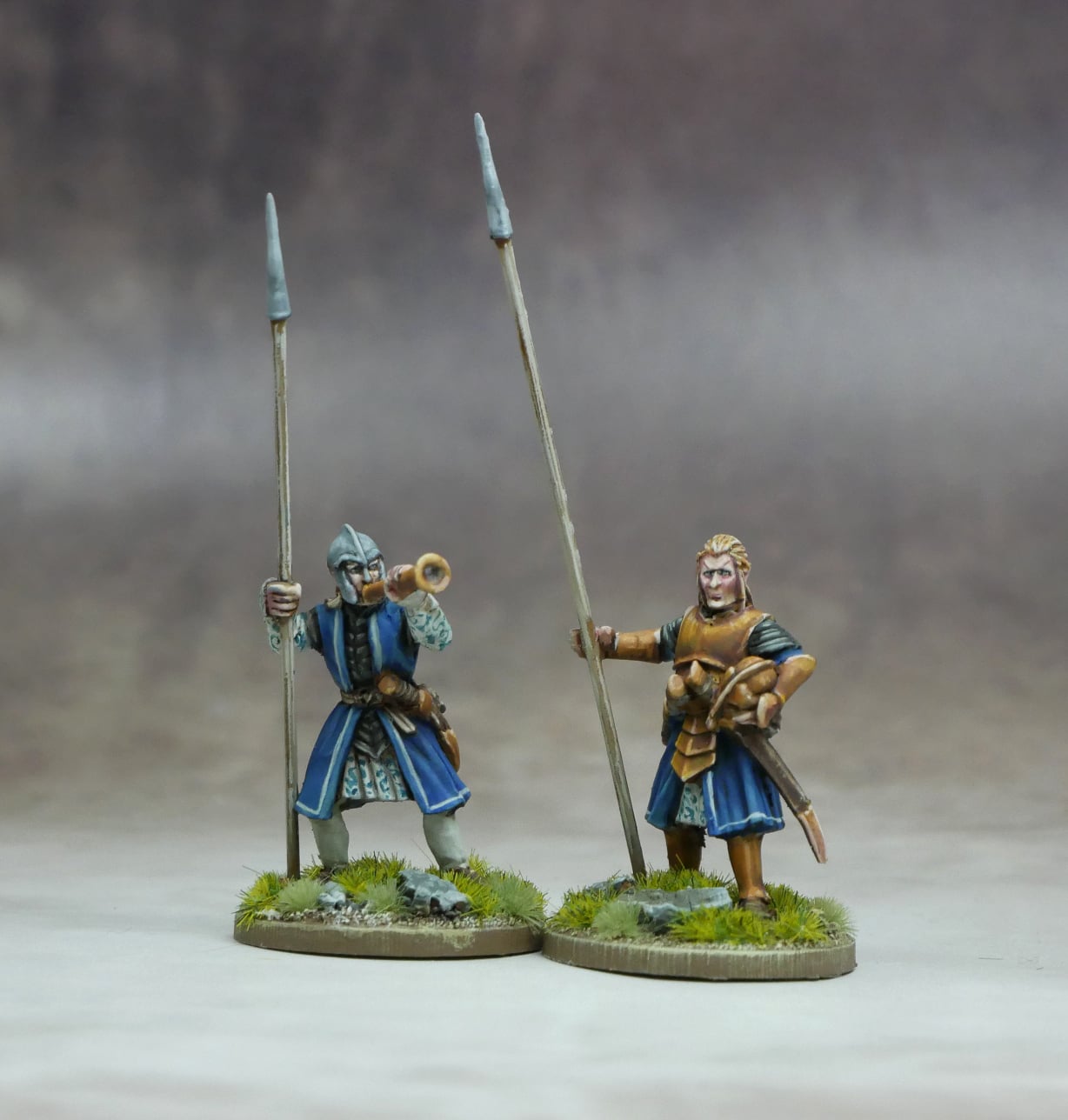 Elven Command Group featuring two elven leaders with spears, one playing a horn, set against a neutral background.