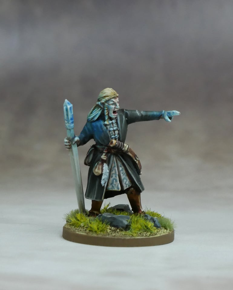 A detailed Elf High Mage miniature figure with a blue staff, showcasing mastery of life magic in a natural setting.