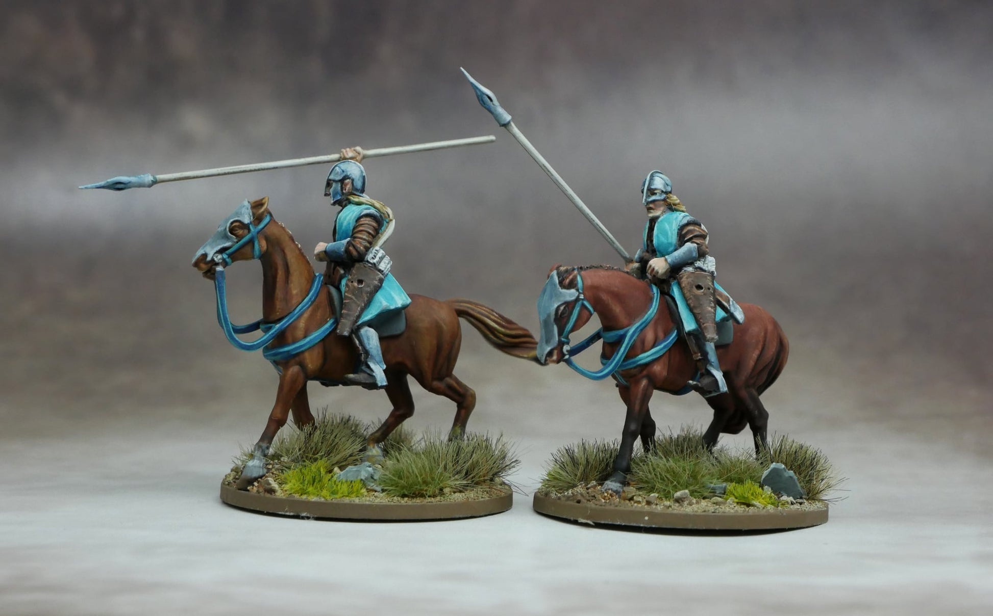 Elven Light Cavalry figures with spears riding agile warhorses through a grassy terrain.