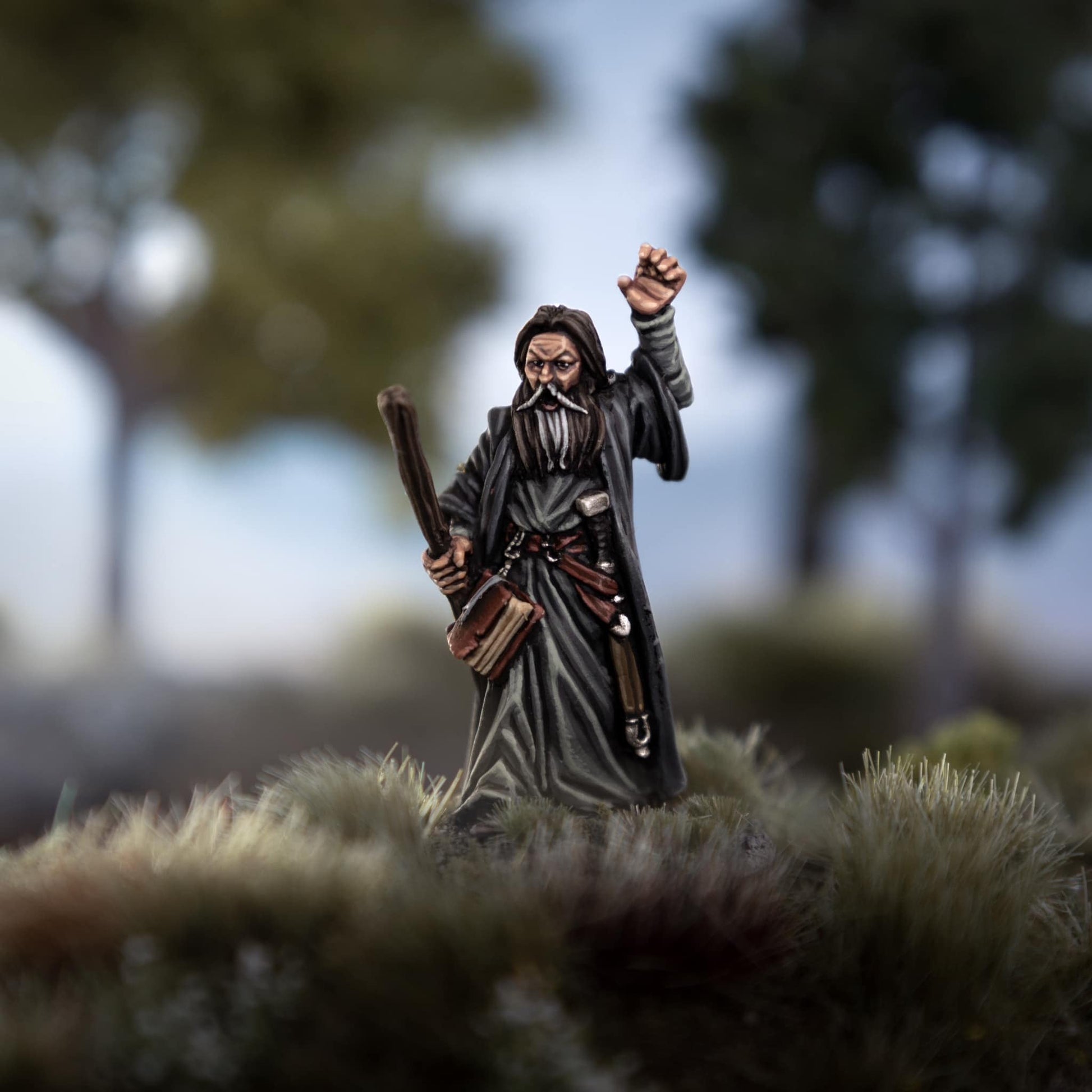 Mordrin Blackfire, the powerful human wizard figure, standing with raised fist in a mystical landscape.