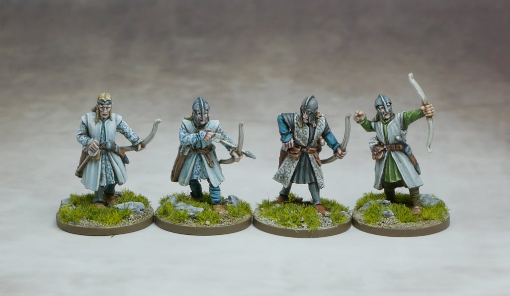 Set of four Elven Archers figurines, showcasing intricate designs and detailed features on a grassy base.