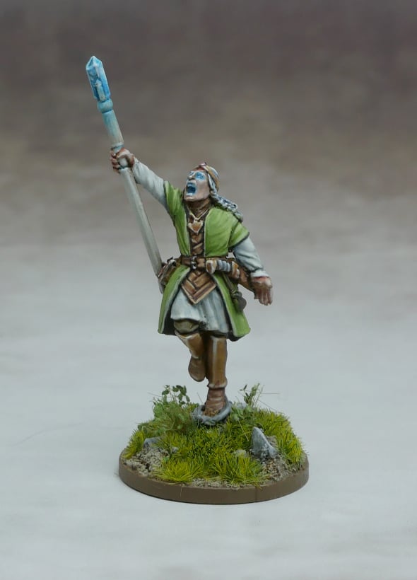 Mhanadir, Storm Mage & Elven Guardians figure holding a staff with a blue crystal, dressed in green robes.